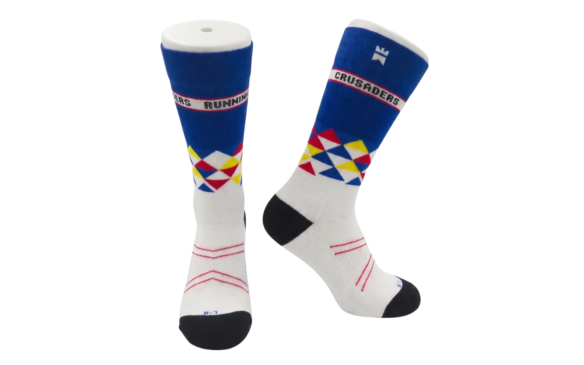 Crusaders Running Club limited edition Gilnokie padded crew socks in white and blue with 'CRUSADERS' and 'RUNNING' text bands and colourful geometric triangle patterns, available in sizes 3–7 and 8–12